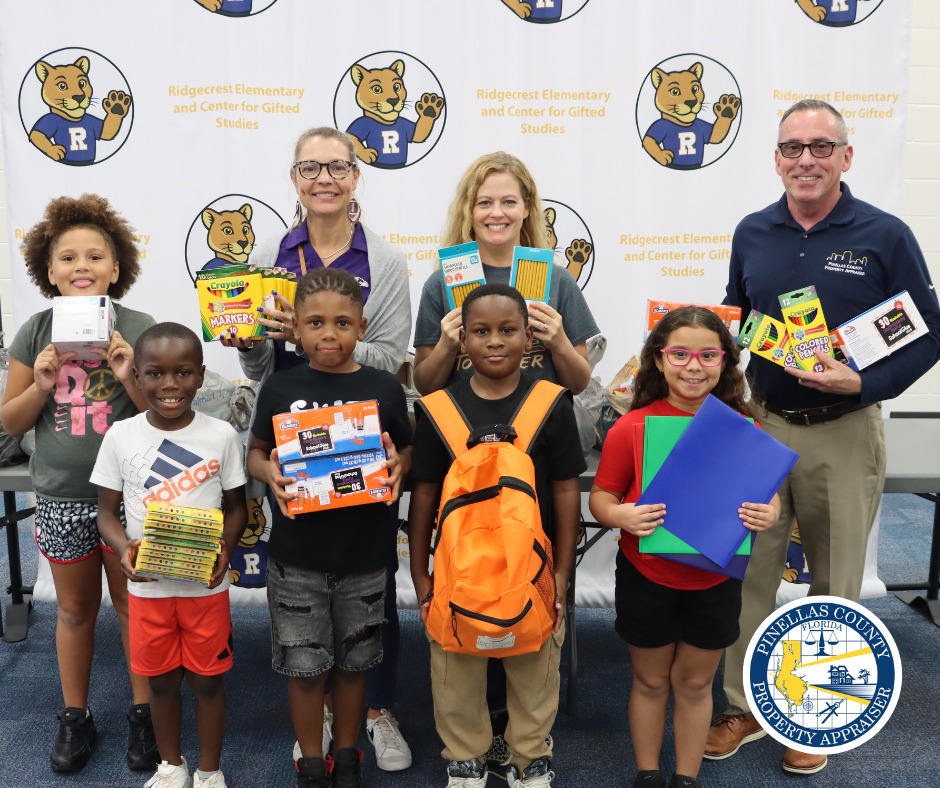 Teachers and students holding school supplies